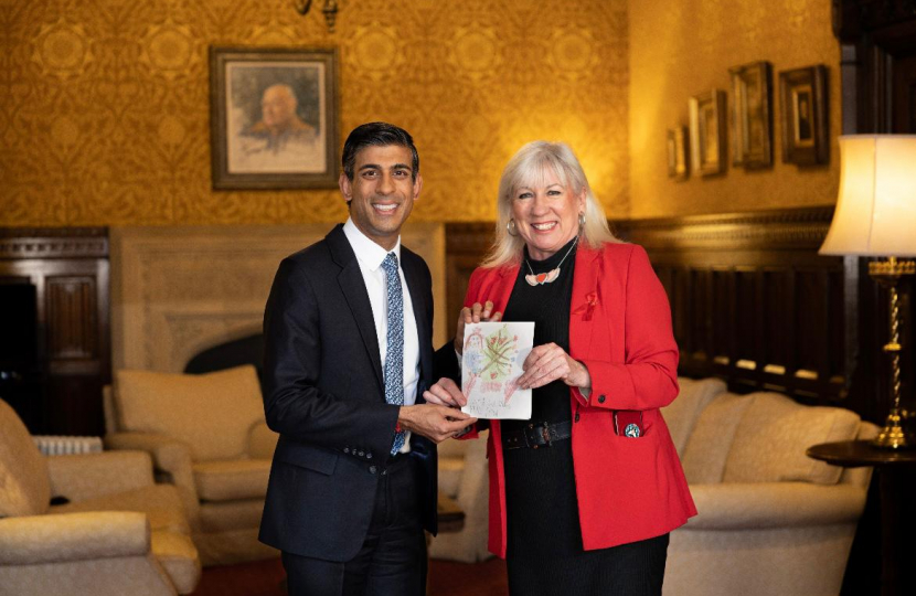 Amanda pictured with the Prime Minister Rishi Sunak and the winning Christmas card